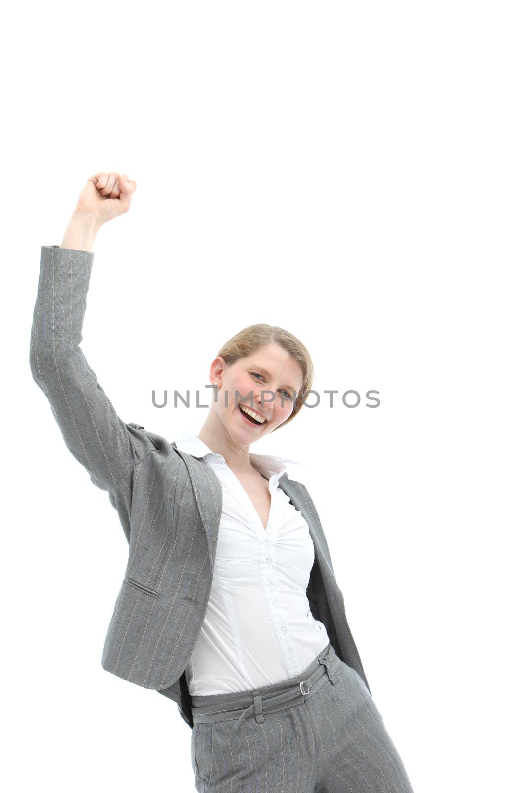 Motivated enthusiastic woman in stylish grey slacksuit punching the air confidently with her fist