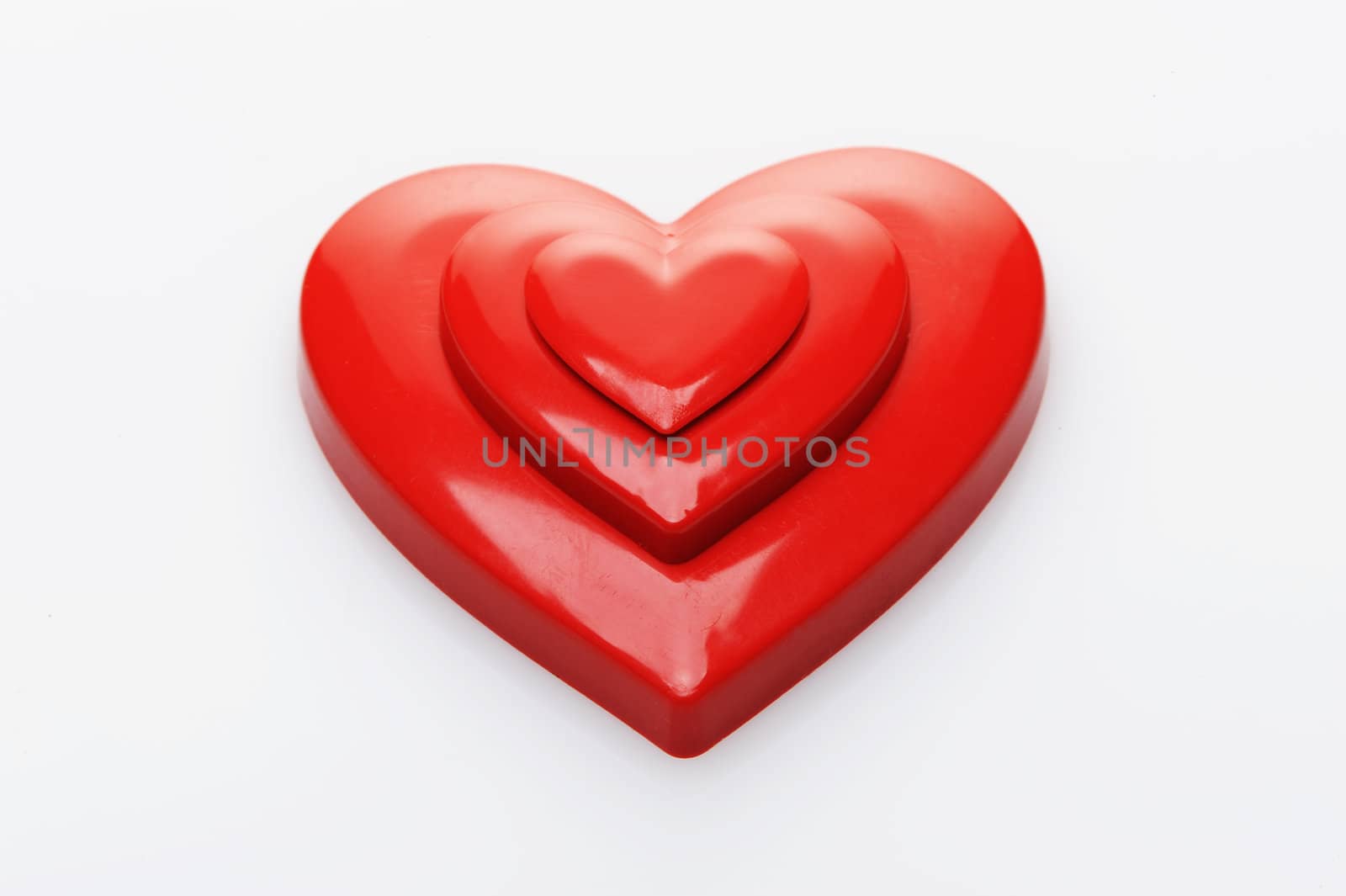 red hearts on white background by stokkete