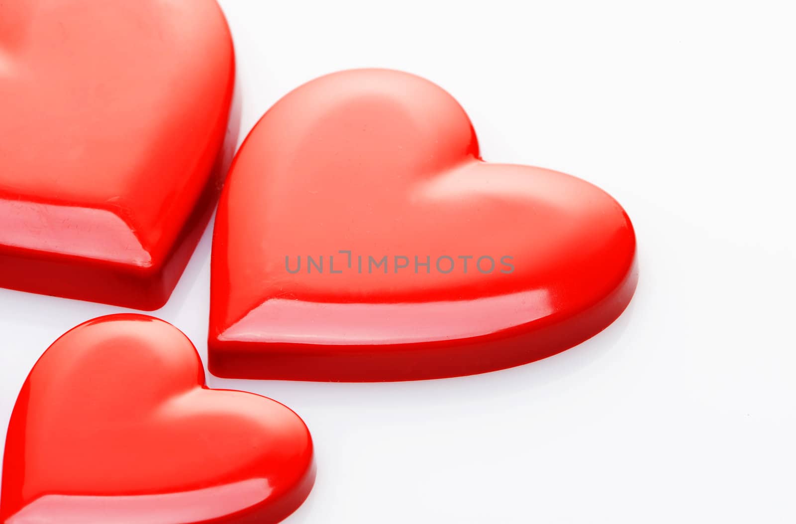 red hearts on white background by stokkete