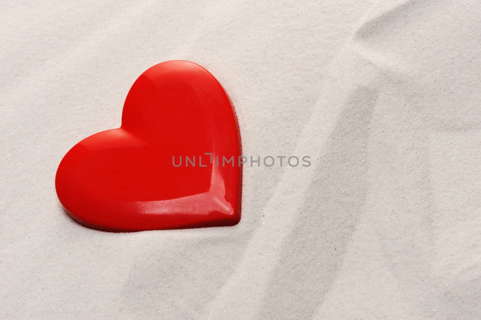 red heart on the sand