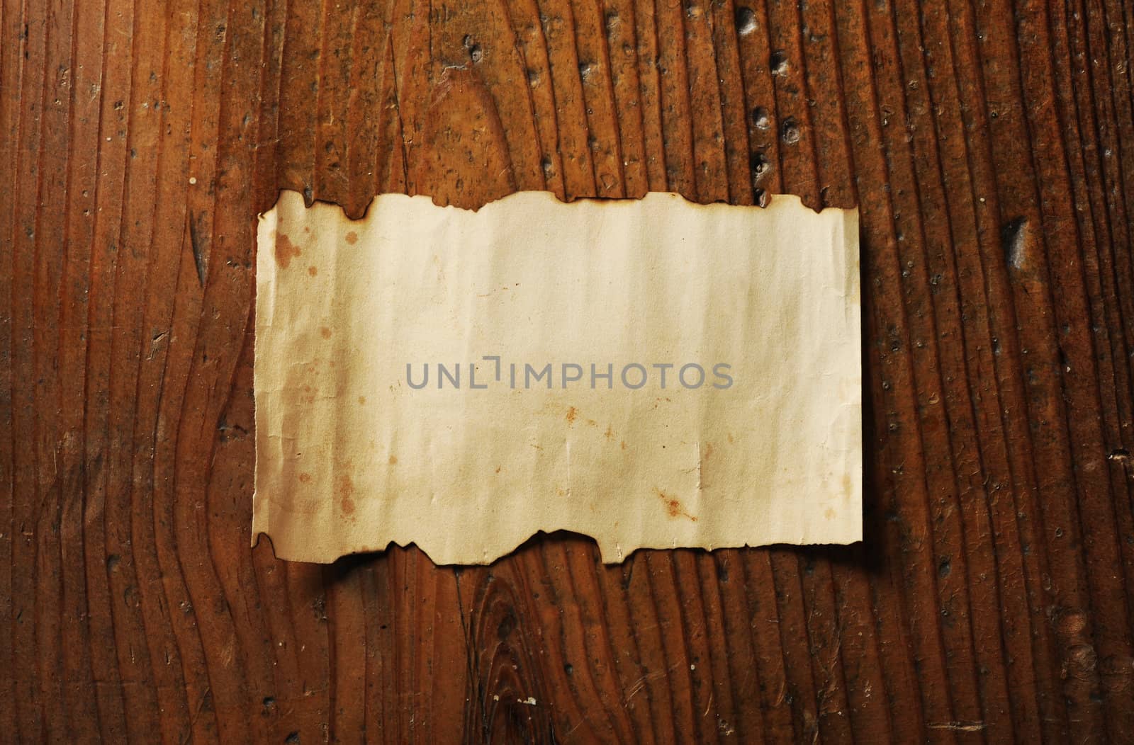 old paper on wooden background by stokkete