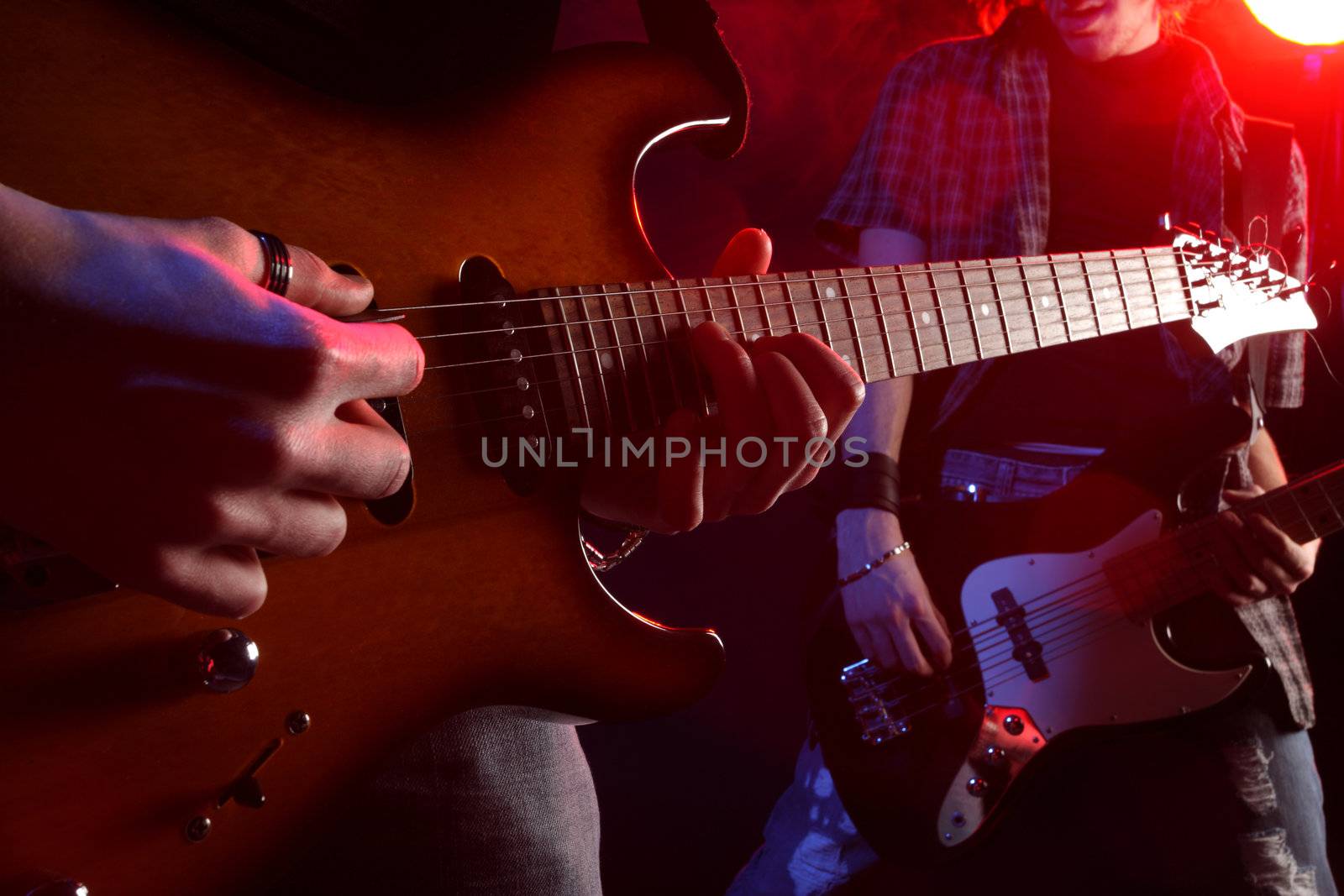 rock musicians playing at a live concert, similar photo on my portfolio