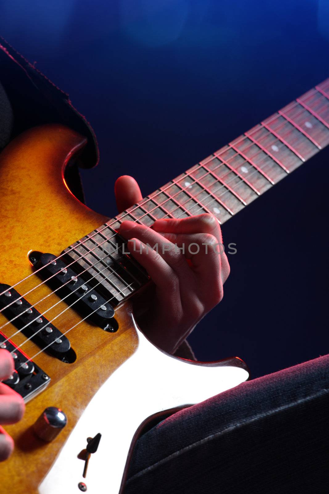 guitar player in action on stage, close up