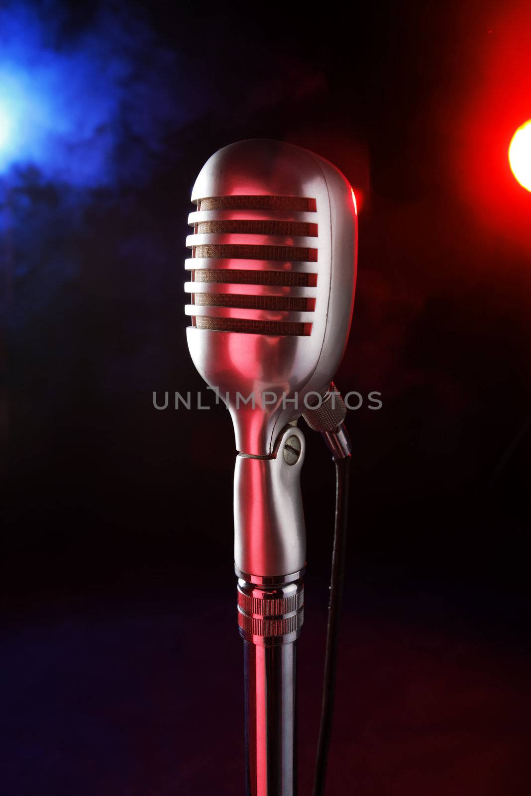 old microphone on a dark background and smoky