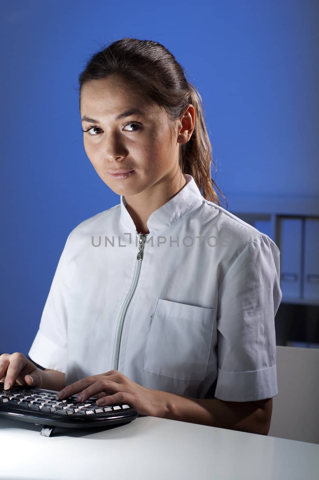 beautiful young woman doctor working at night in the office