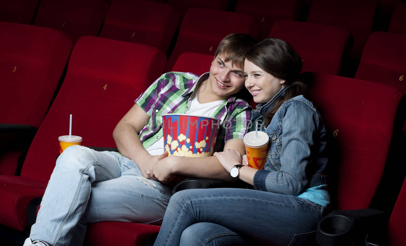 couple in a movie theater, watching a movie