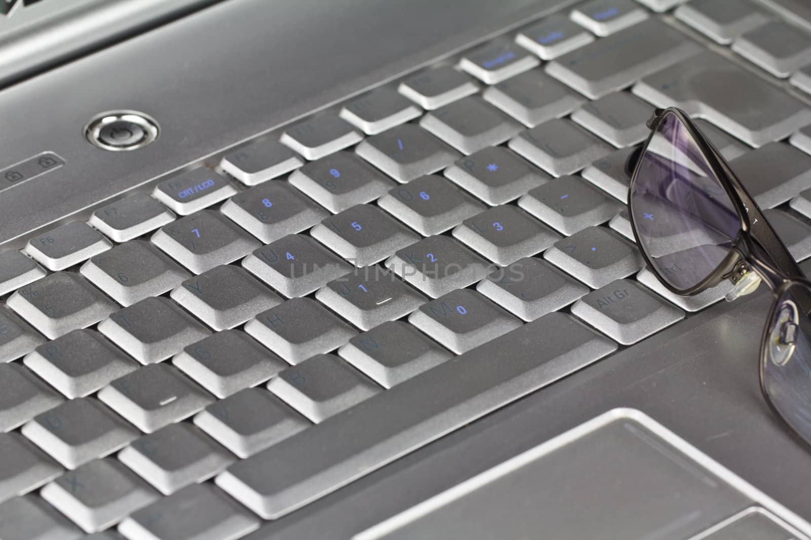 A laptop Keyboard and Glasses