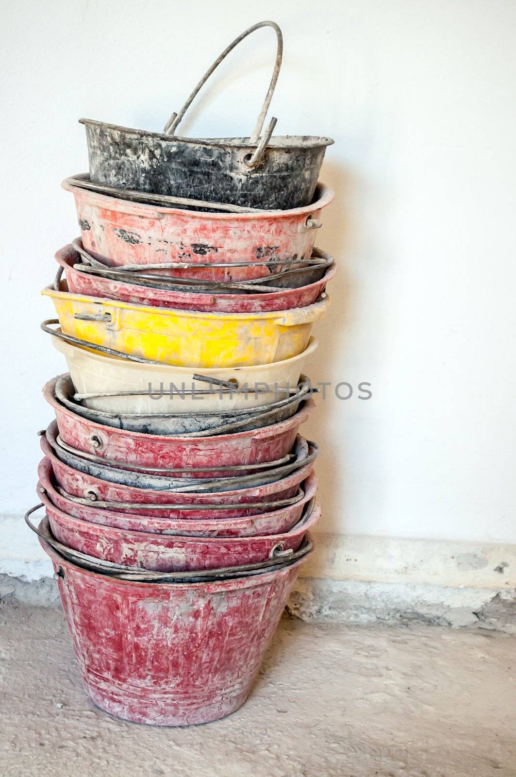 dirty masonry buckets on white wall background