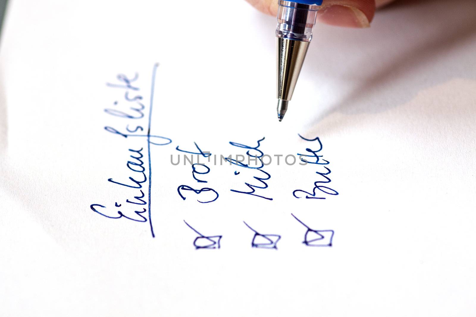 handwritten shopping list on white paper in german