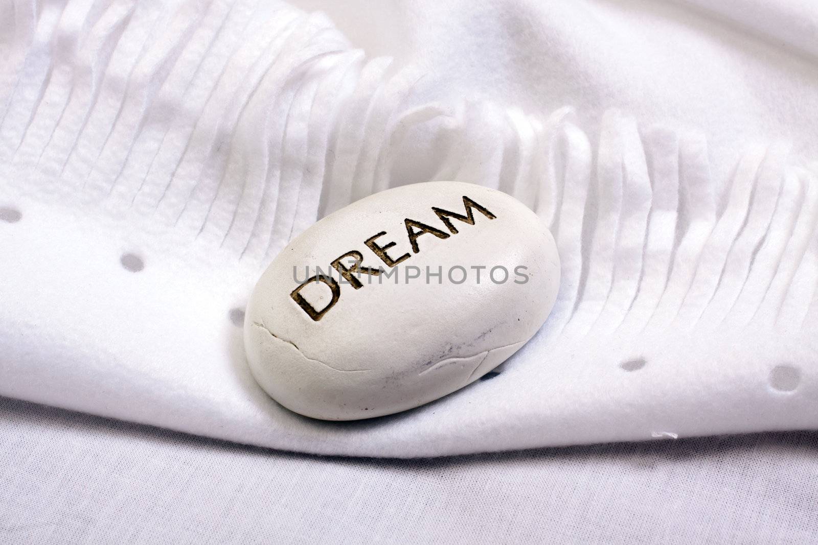 white dream stone on a white blanket  by juniart