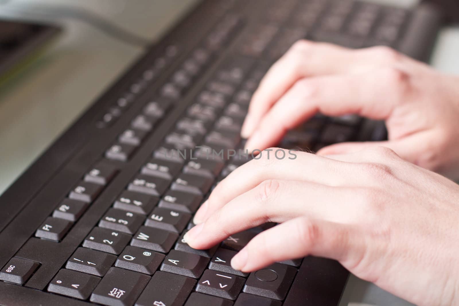 womans hand on a coumputer keyboard by juniart