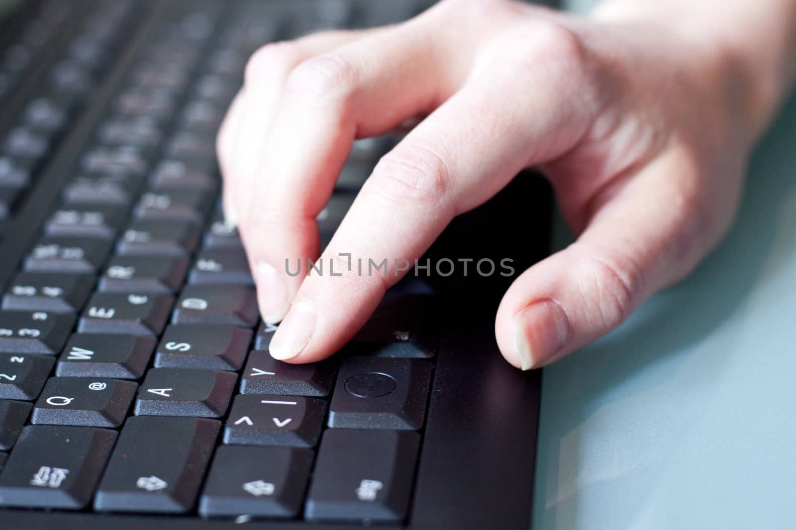 womans hand on a coumputer keyboard