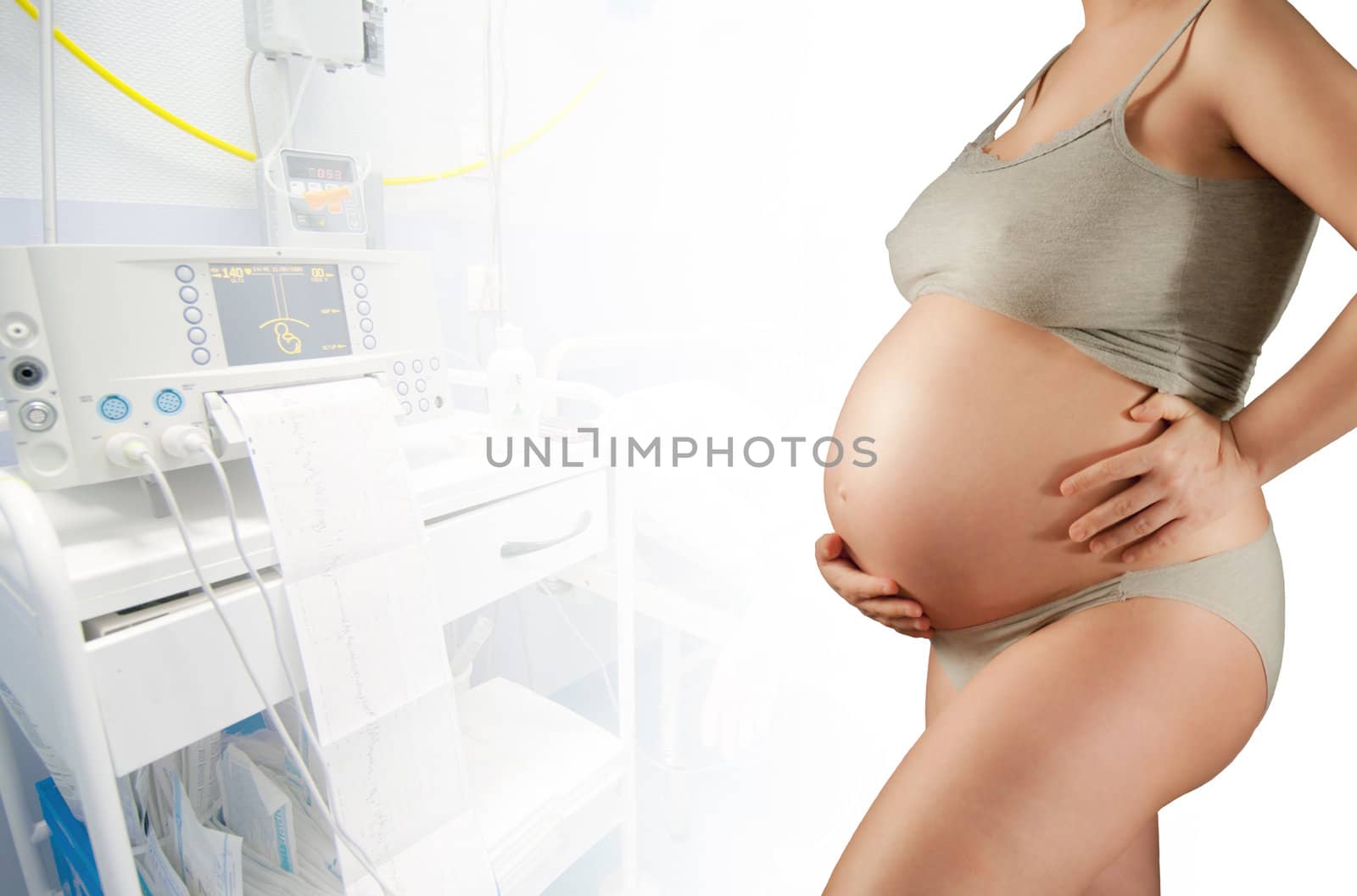 Pregnant in a hospital, white corridor