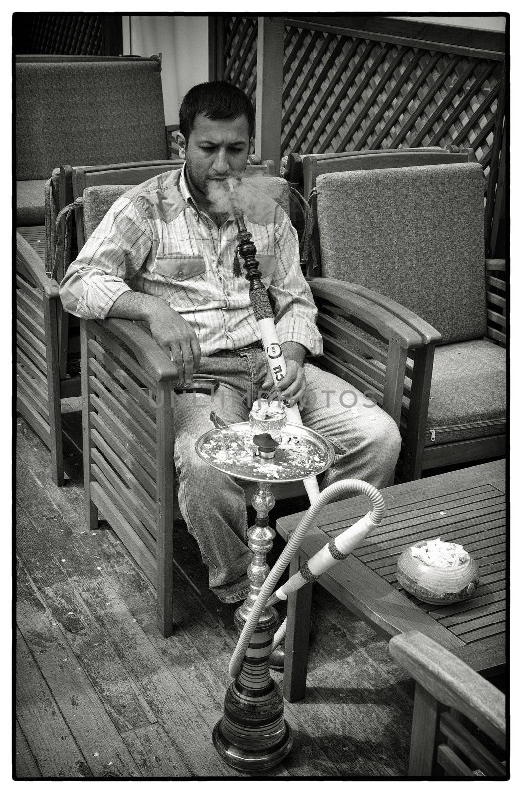 Man smoking waterpipe by ABCDK