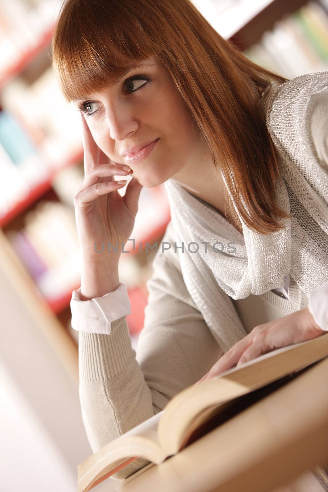 Teen girl learning at the desk, looking up 