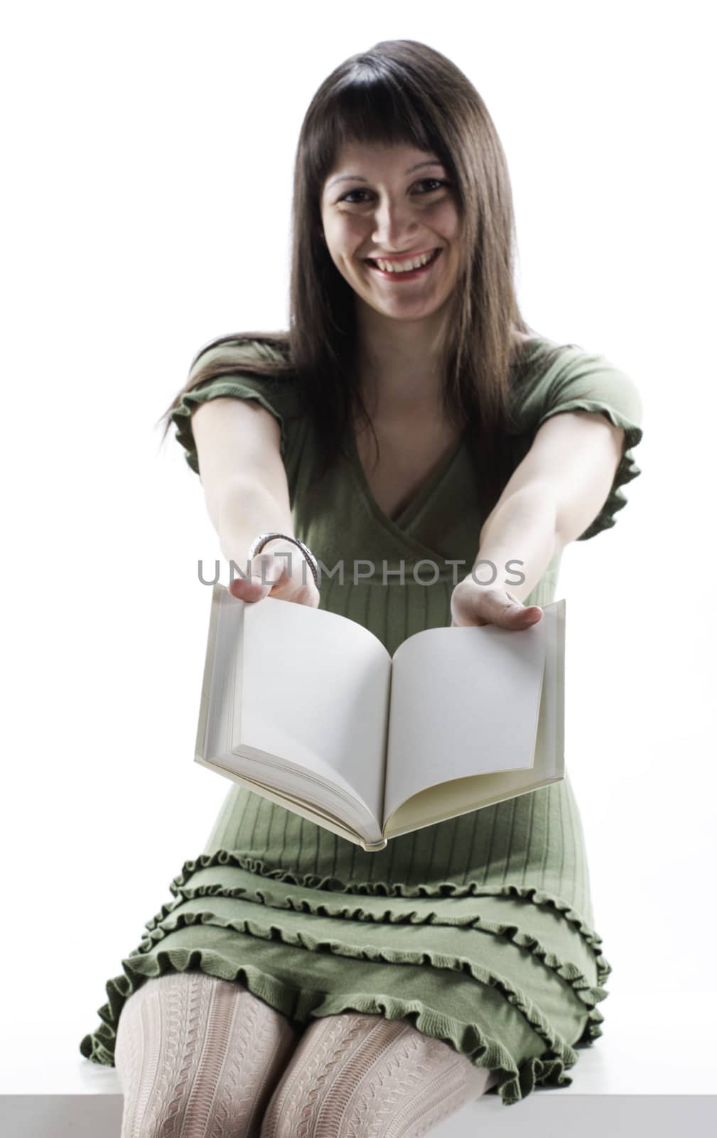 young Woman holding an open book . Pages are blank by stokkete
