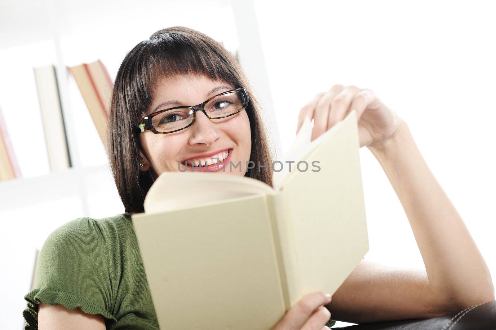 young woman woman with book , bookshelf on background