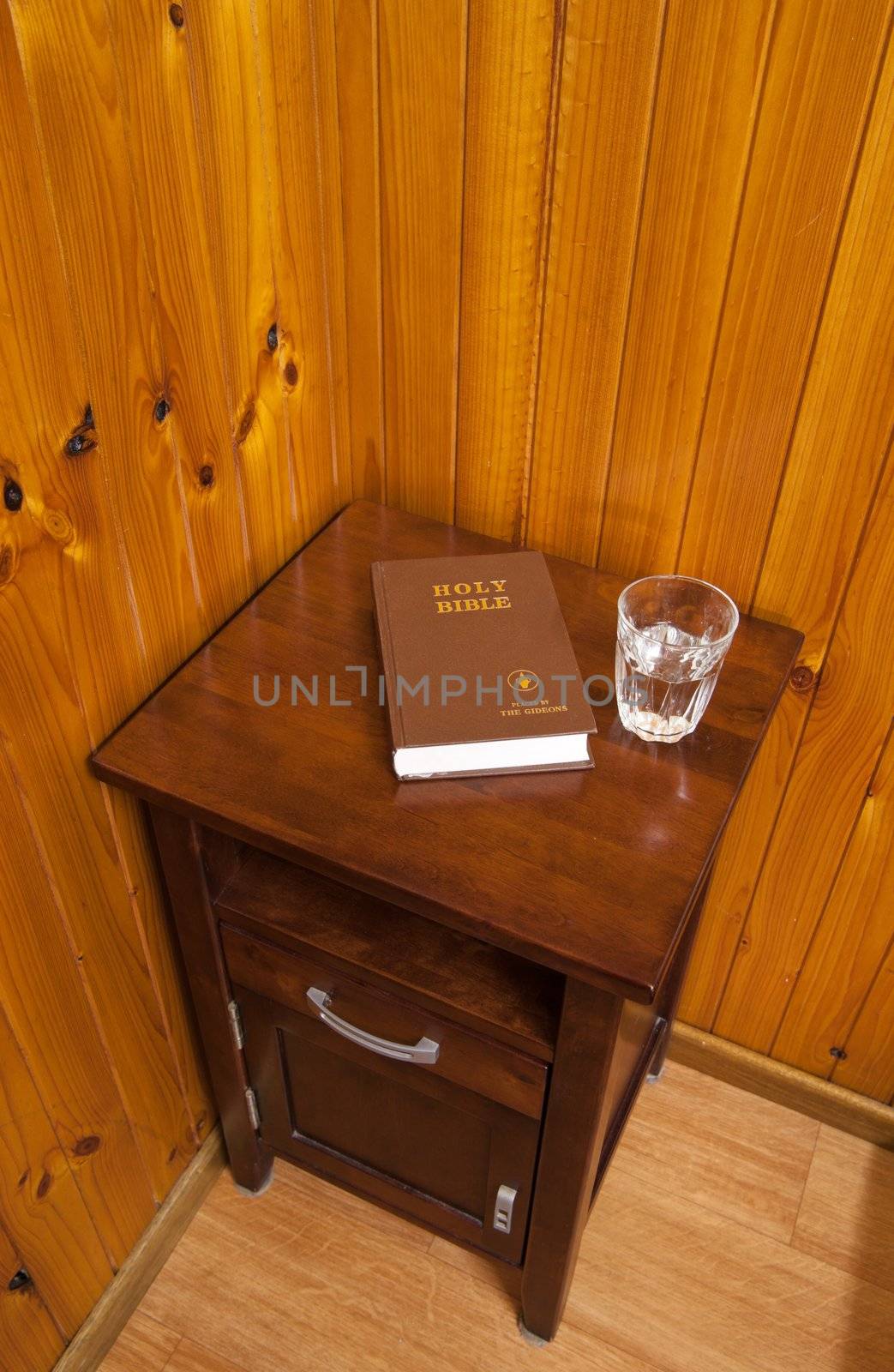 bible on bed side table in cheap hotel room