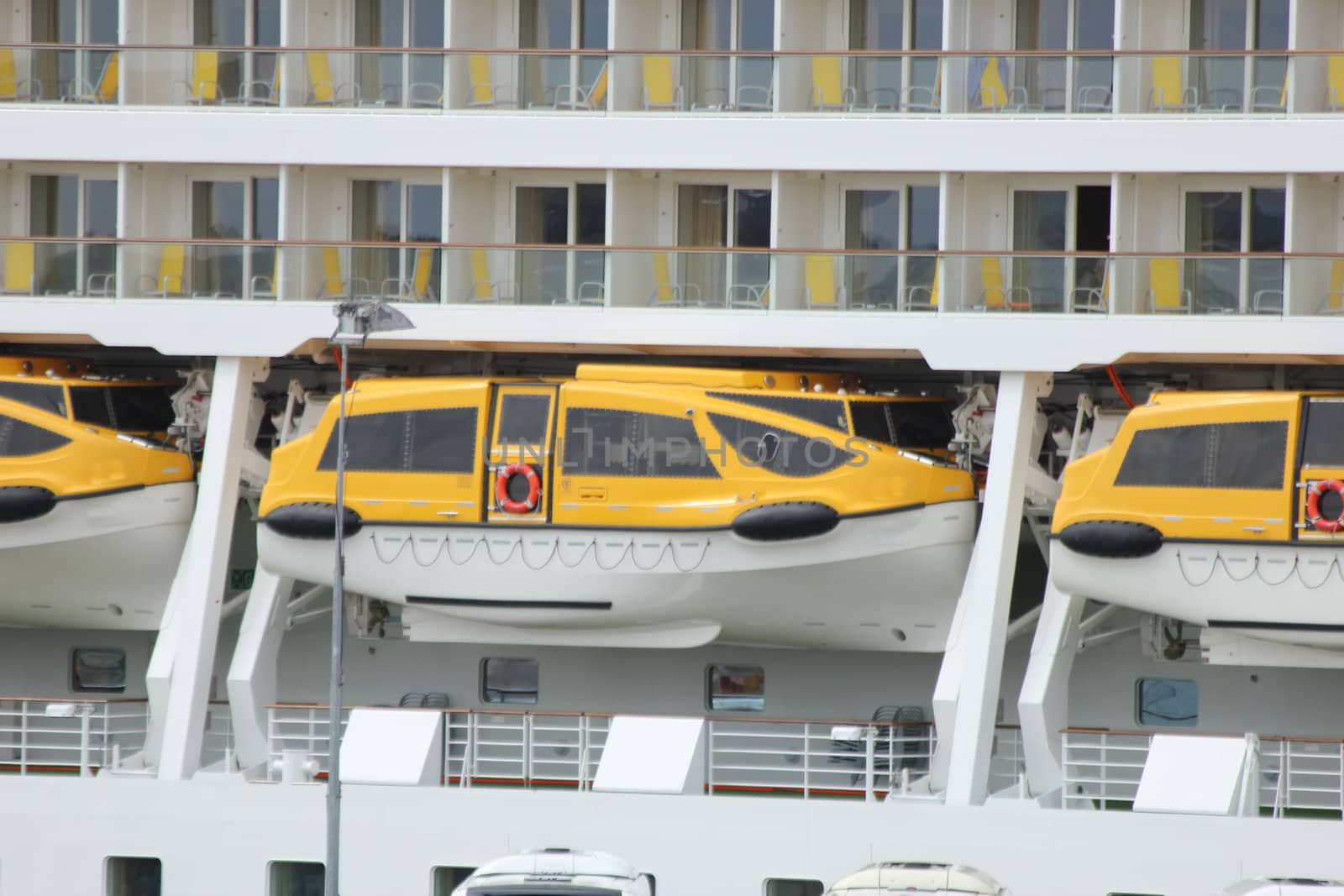 A row of safety lifeboats on a big cruise ship