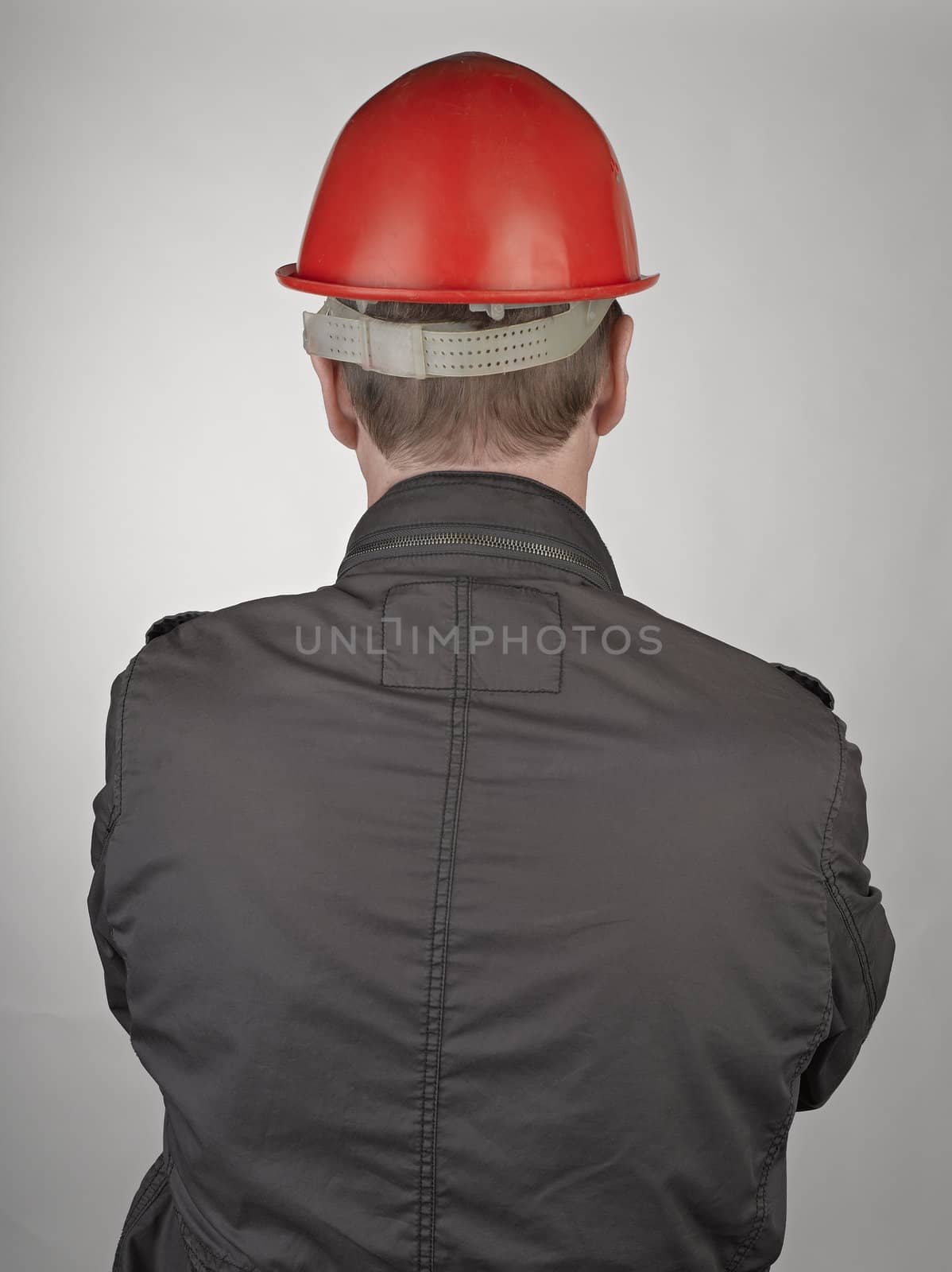 Back of worker man on grey background by pbombaert