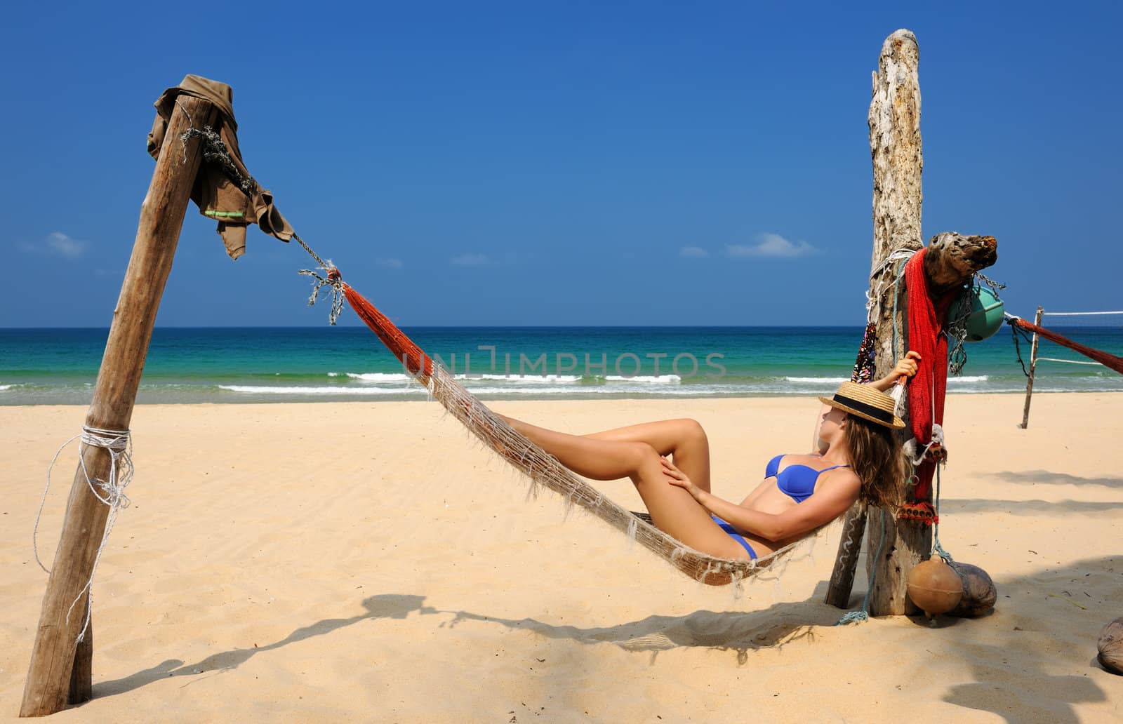 Woman in hammock on beach by haveseen