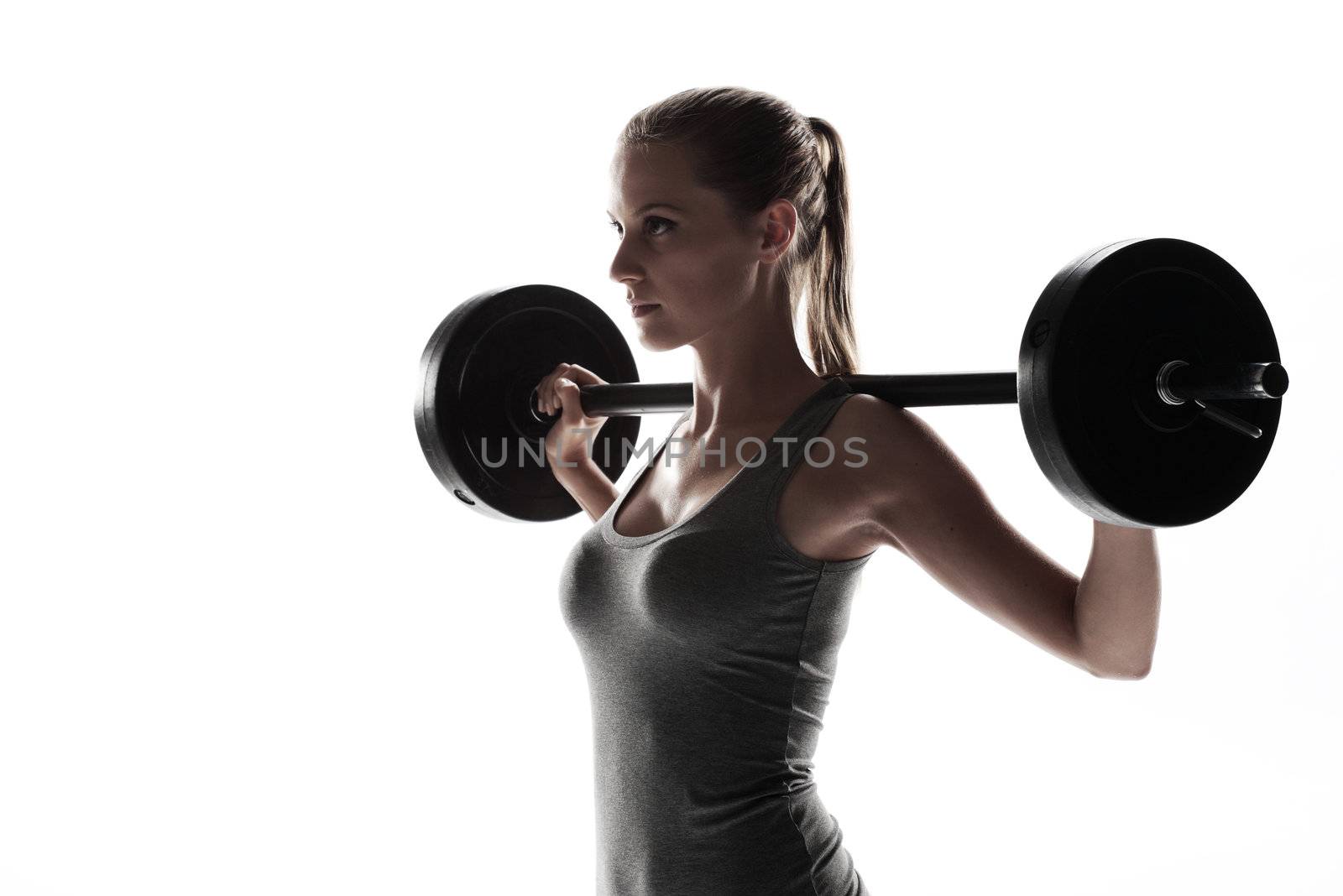 Woman lifting weights by stokkete