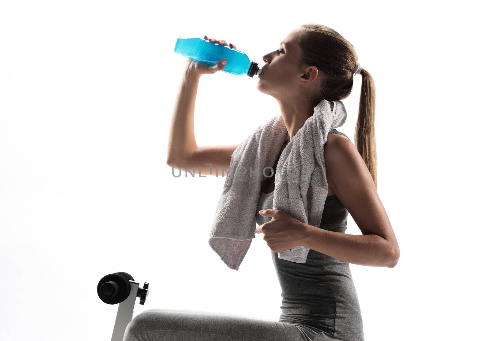 Thirsty young woman drinking after fitness workout. white background

