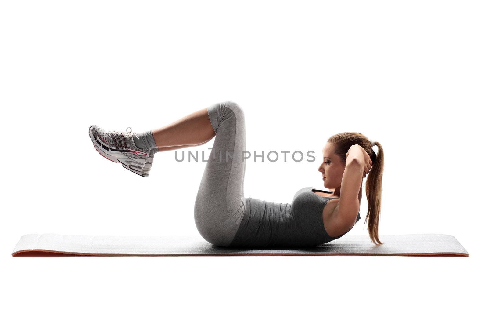 Portrait of a young healthy woman fitness abdominal exercises