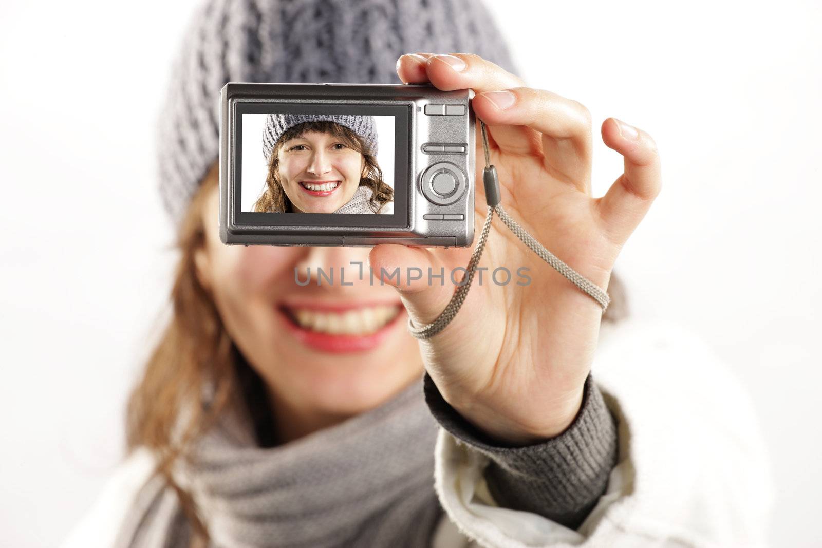 beautiful girl with a camera taking a photo of herself - focus is on camera