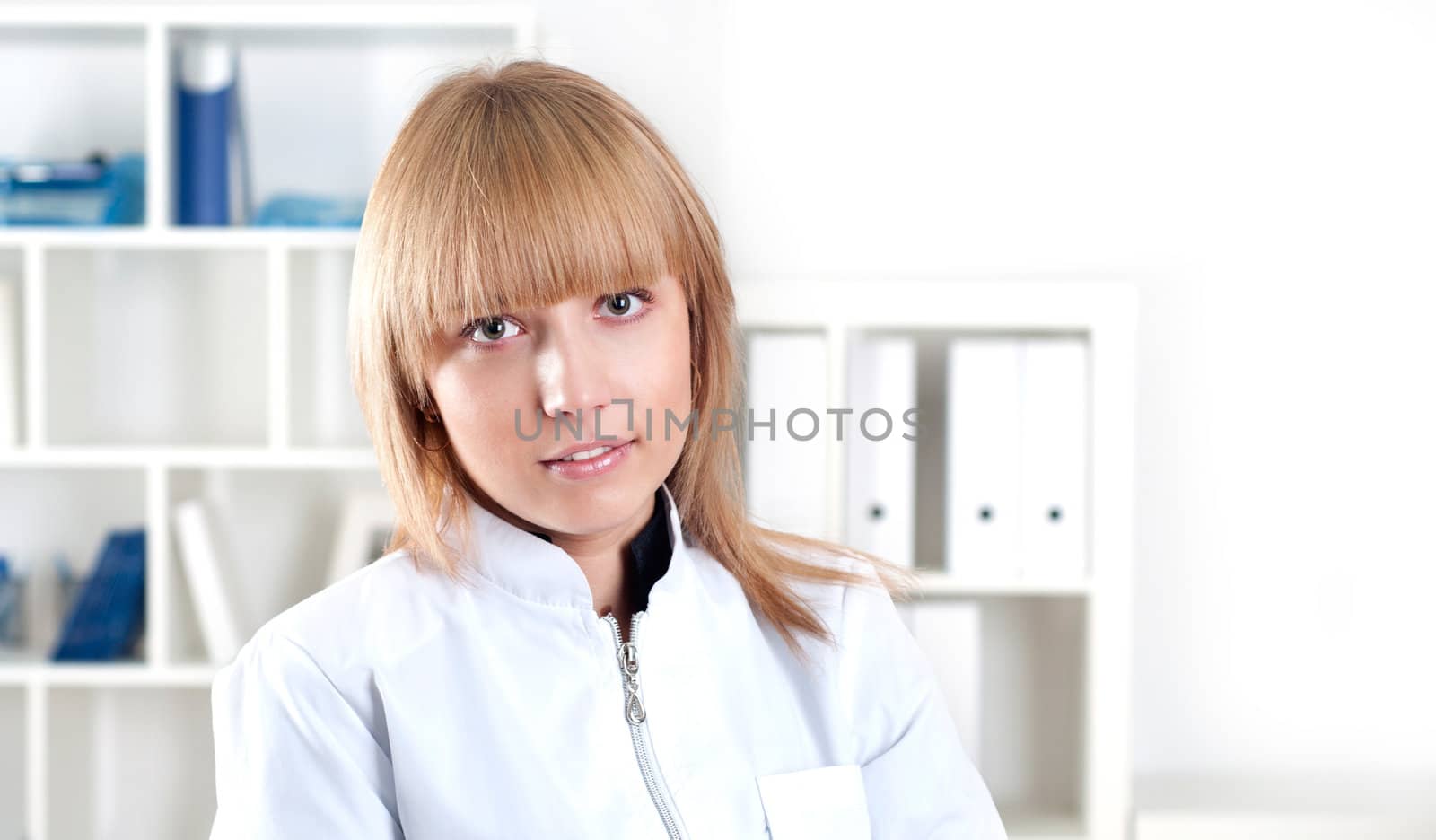 portrait of a beautiful woman doctor standing with folded arms