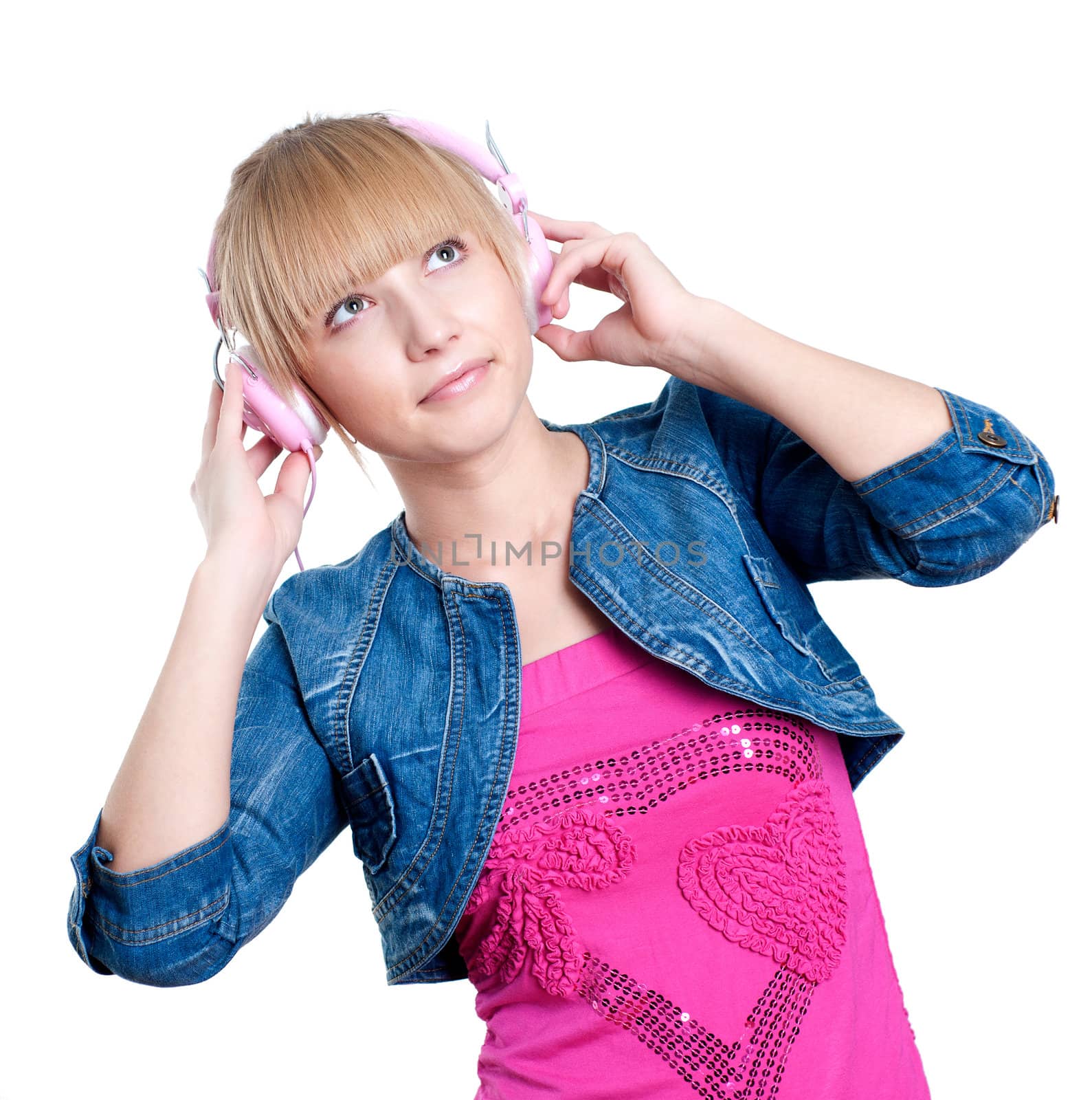 Young attractive woman listing to music with headphones against white background