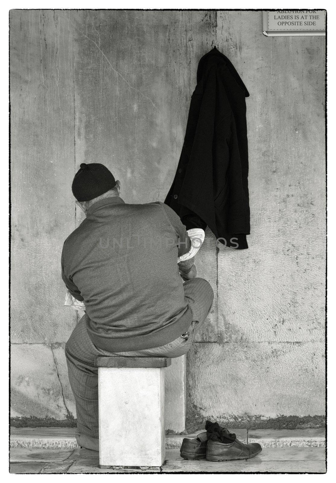 Muslim man washing his feet, hands and face before the prayer in the mosque, Istanbul, 