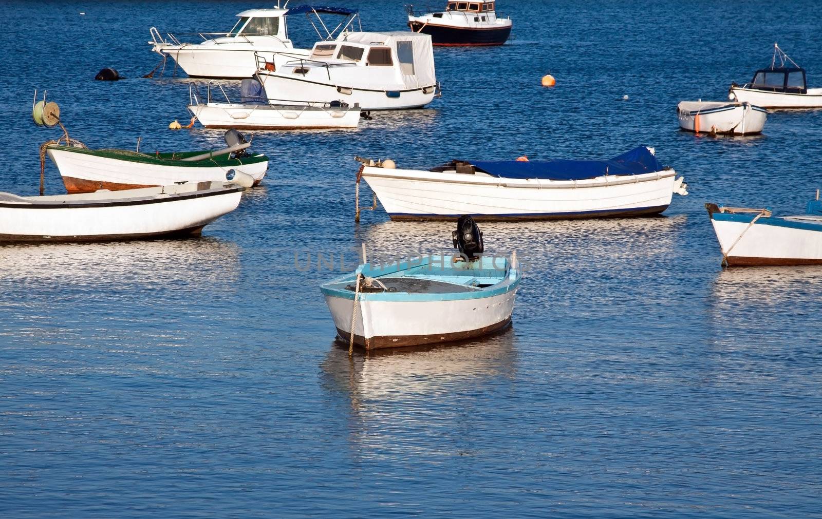 several fishing boats relax on spring sun