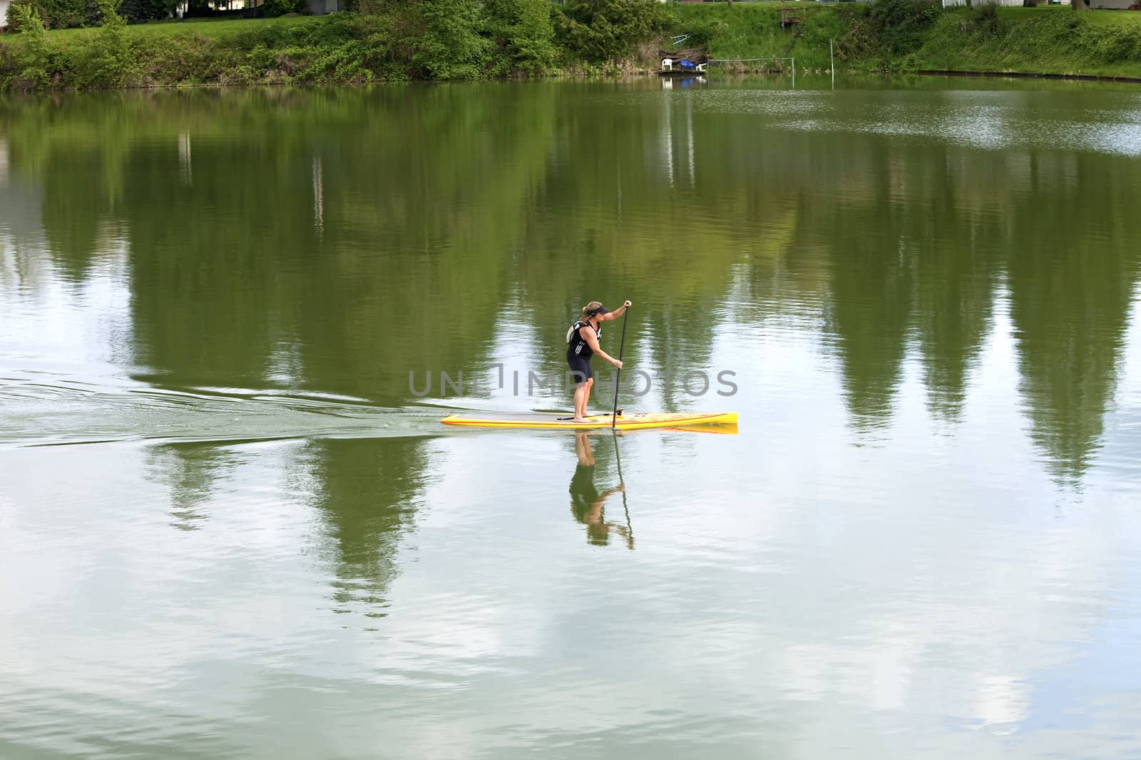 A woman paddling in a lake, Woodland WA.