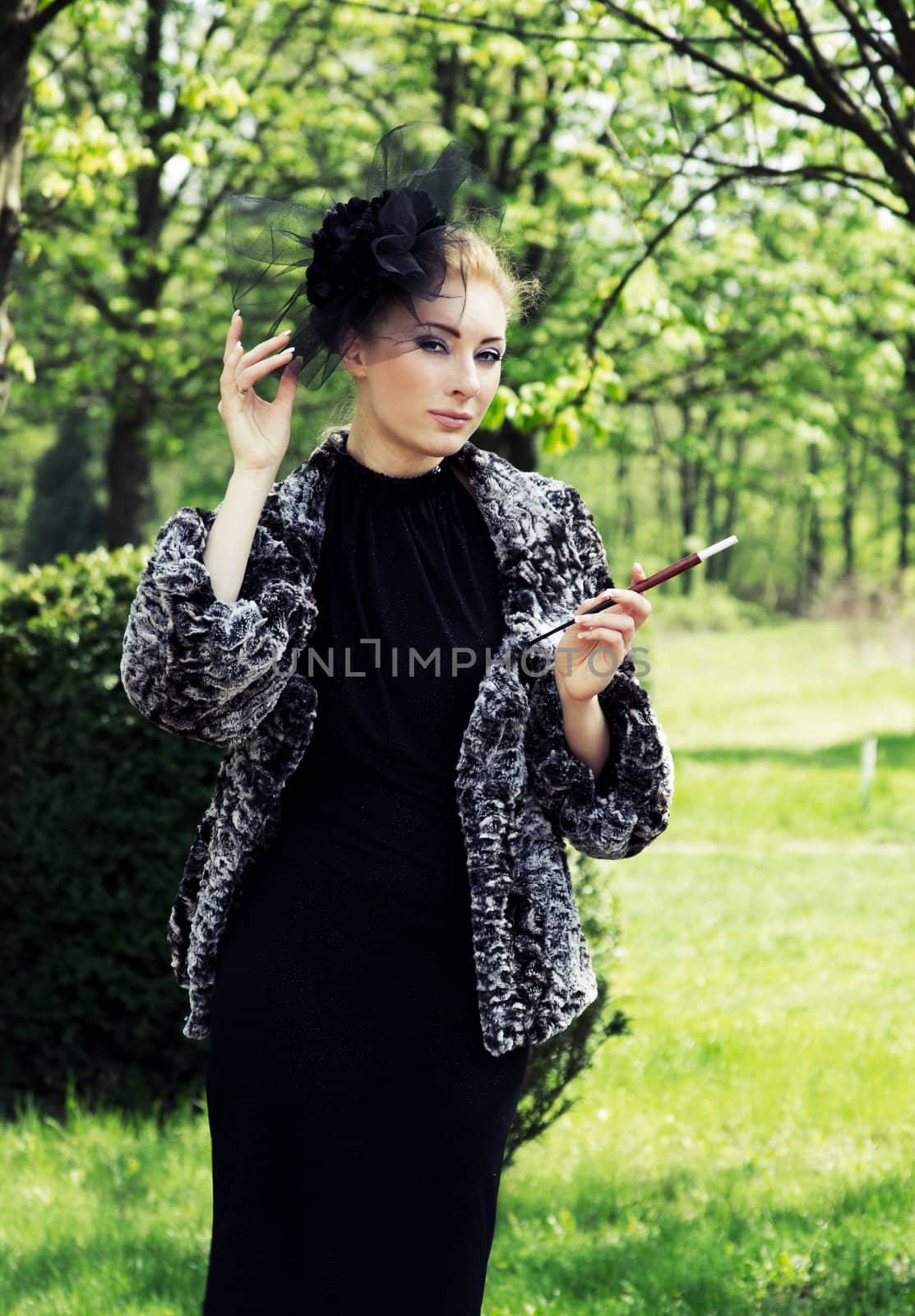 Retro-styled woman with cigarette outdoor