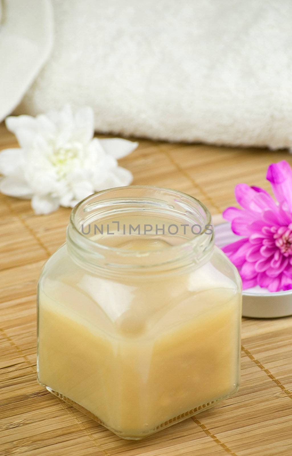 relaxing aroma of almond coconut vanilla milk and honey bath foam over wooden mat