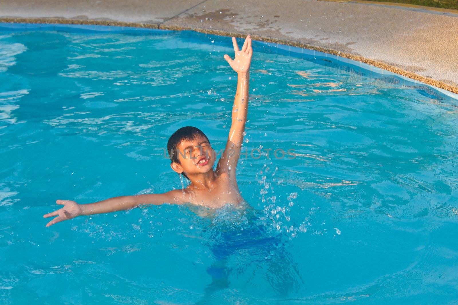 Swimming child showing his enjoyment in the water