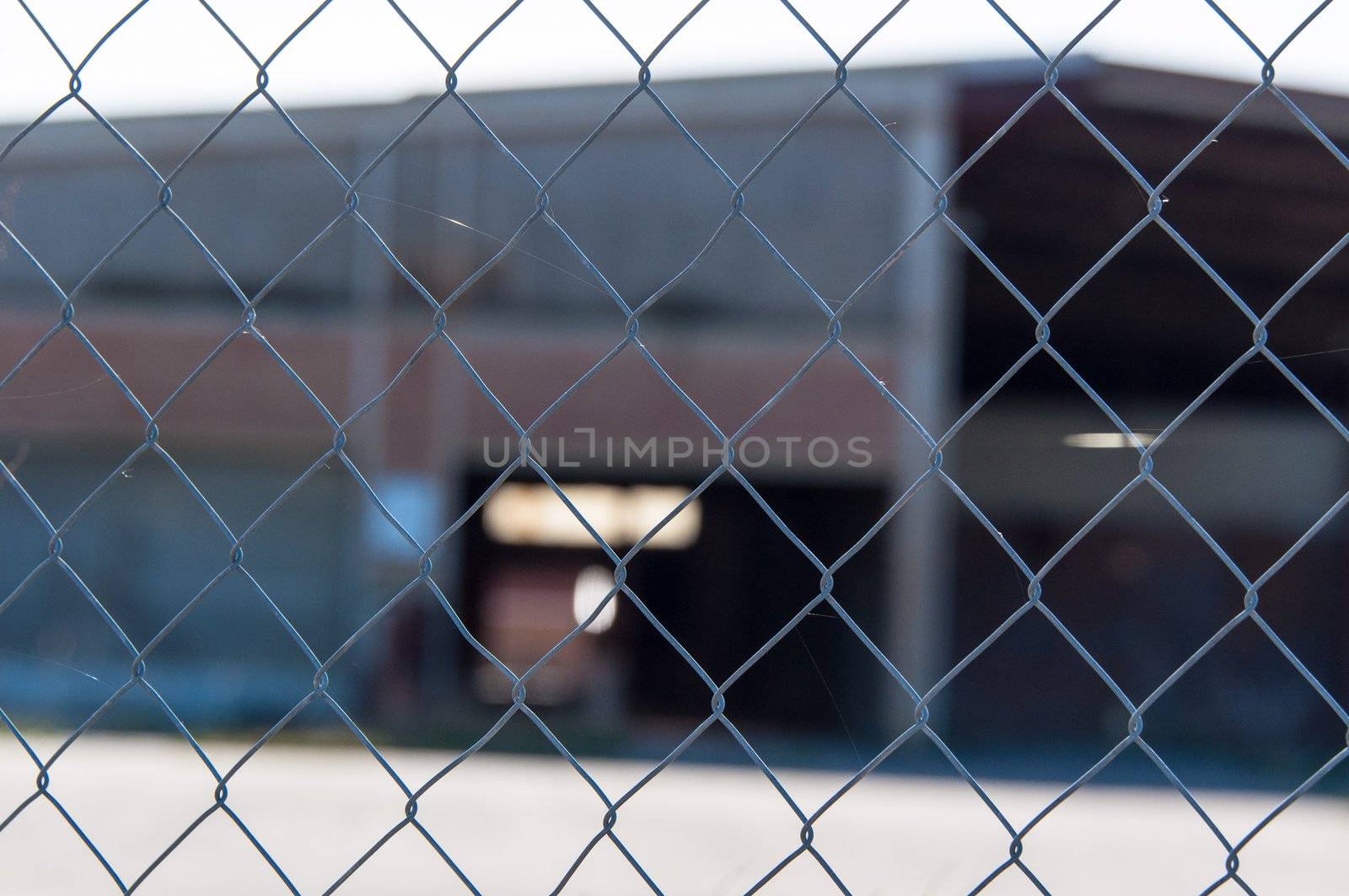 a wire mesh in front of a factory building