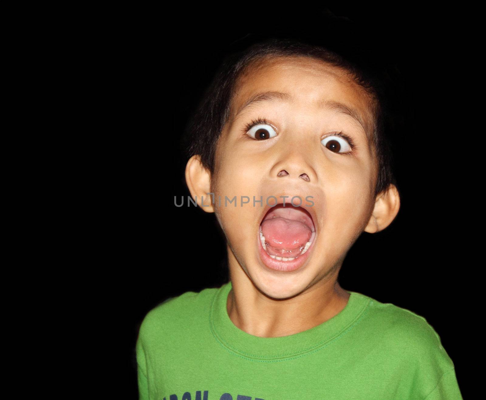 Young asian boy with wide mouth and eyes open in complete amazements