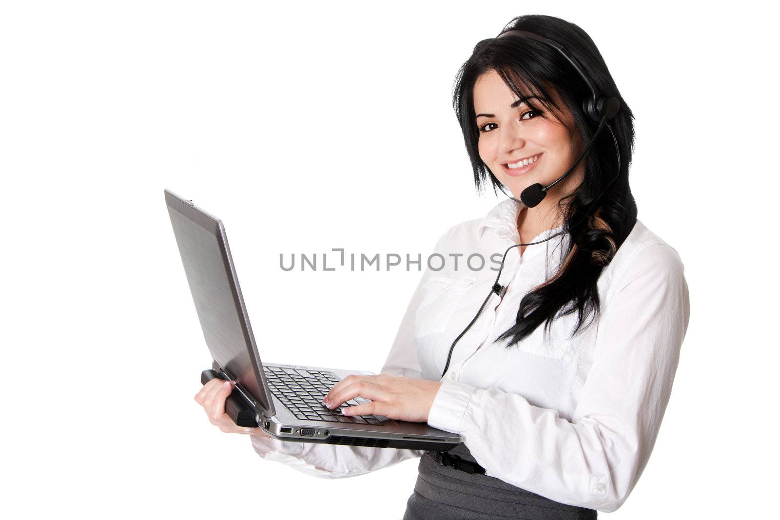 Beautiful happy customer service representative at call center office with headset and laptop computer standing online chatting, isolated.