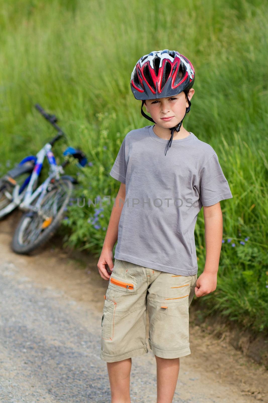 portrait of small boy bicyclist with helmet