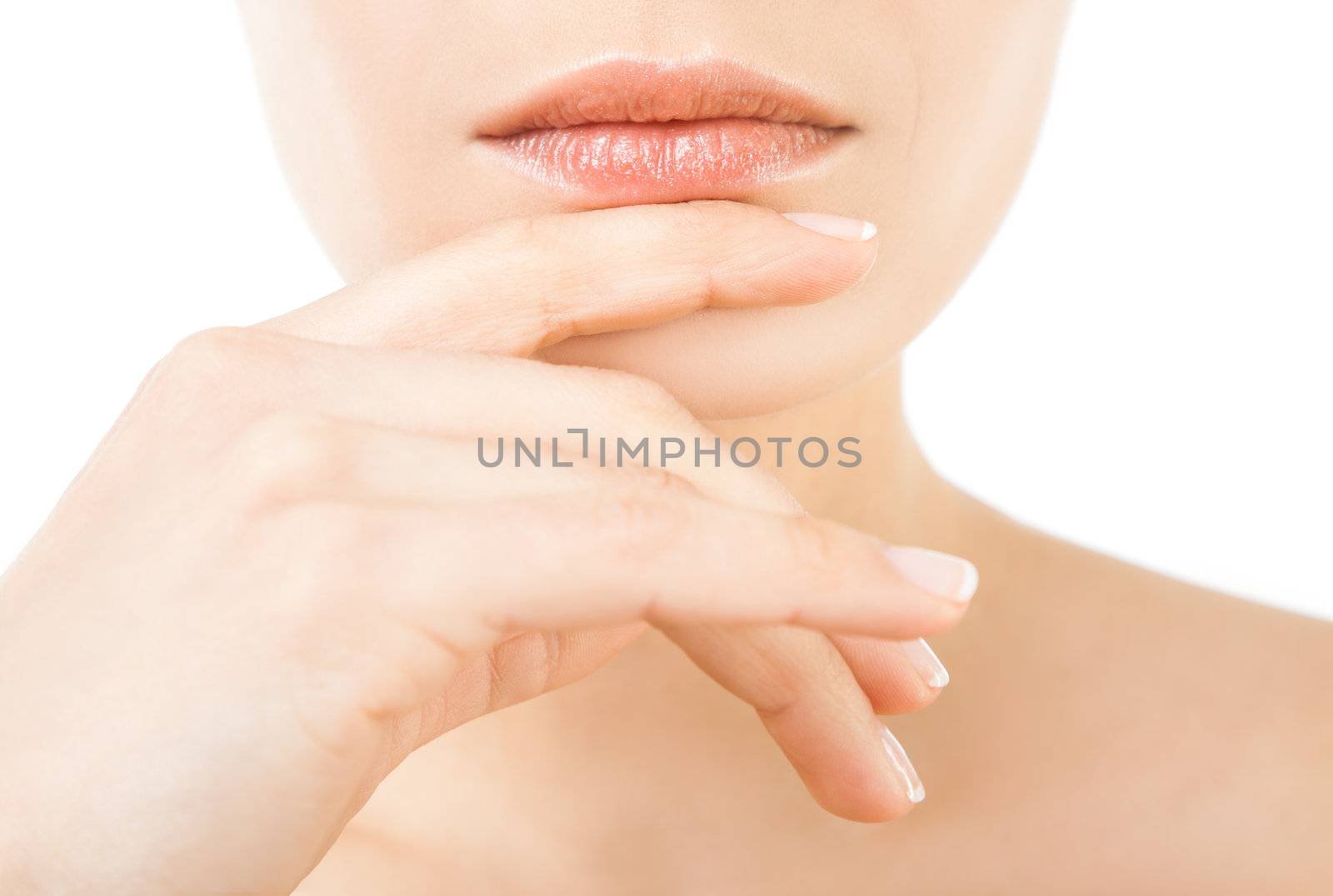 Close-up of beautiful female lips and hand on chin