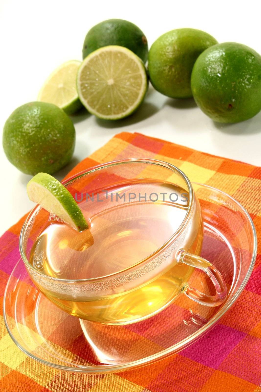 a cup of lemon tea with fresh lime