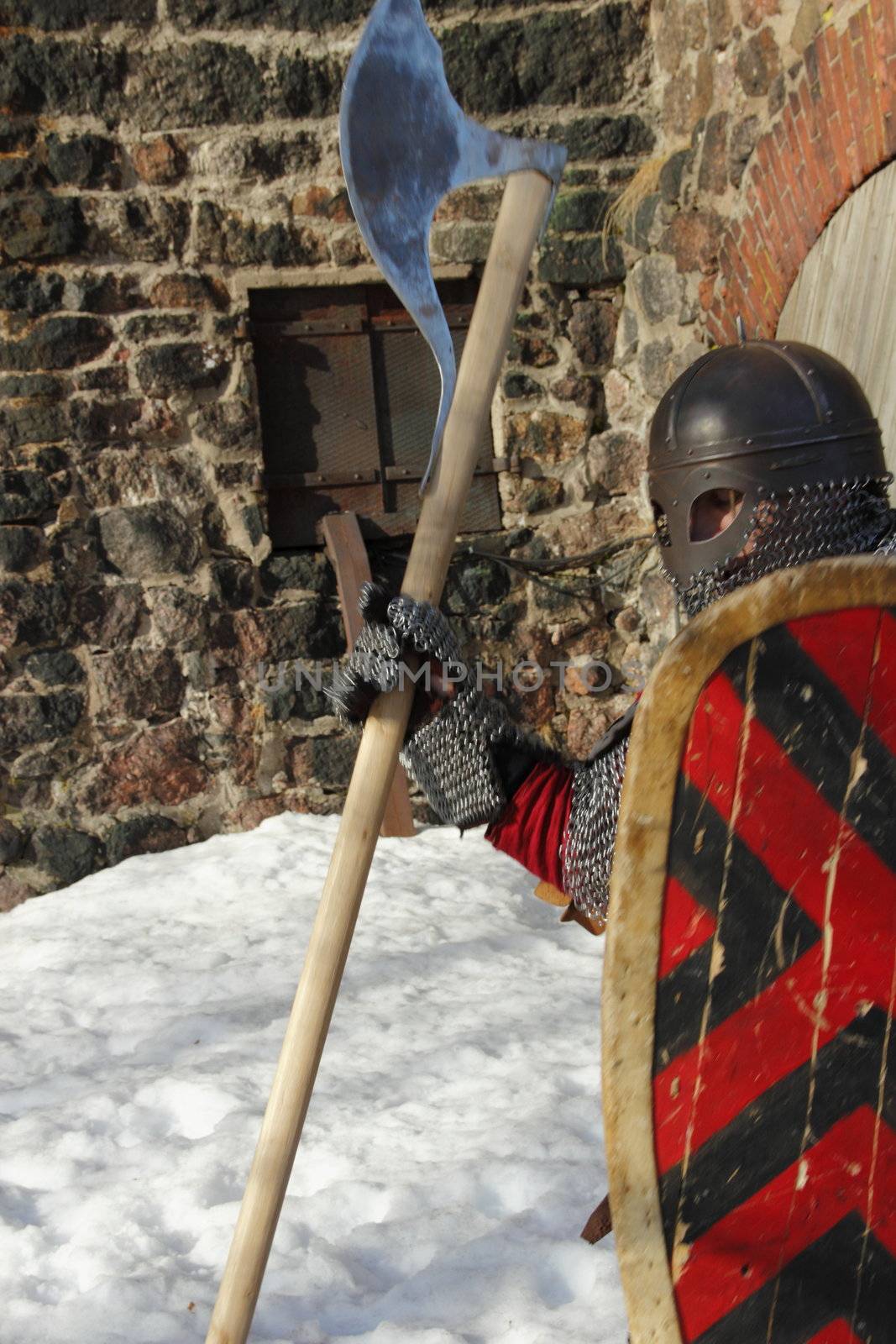 warlike knight in armor against the fortress wall