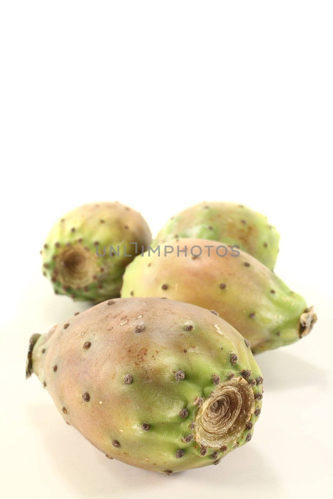 fresh ripe red and green prickly pears on a bright background