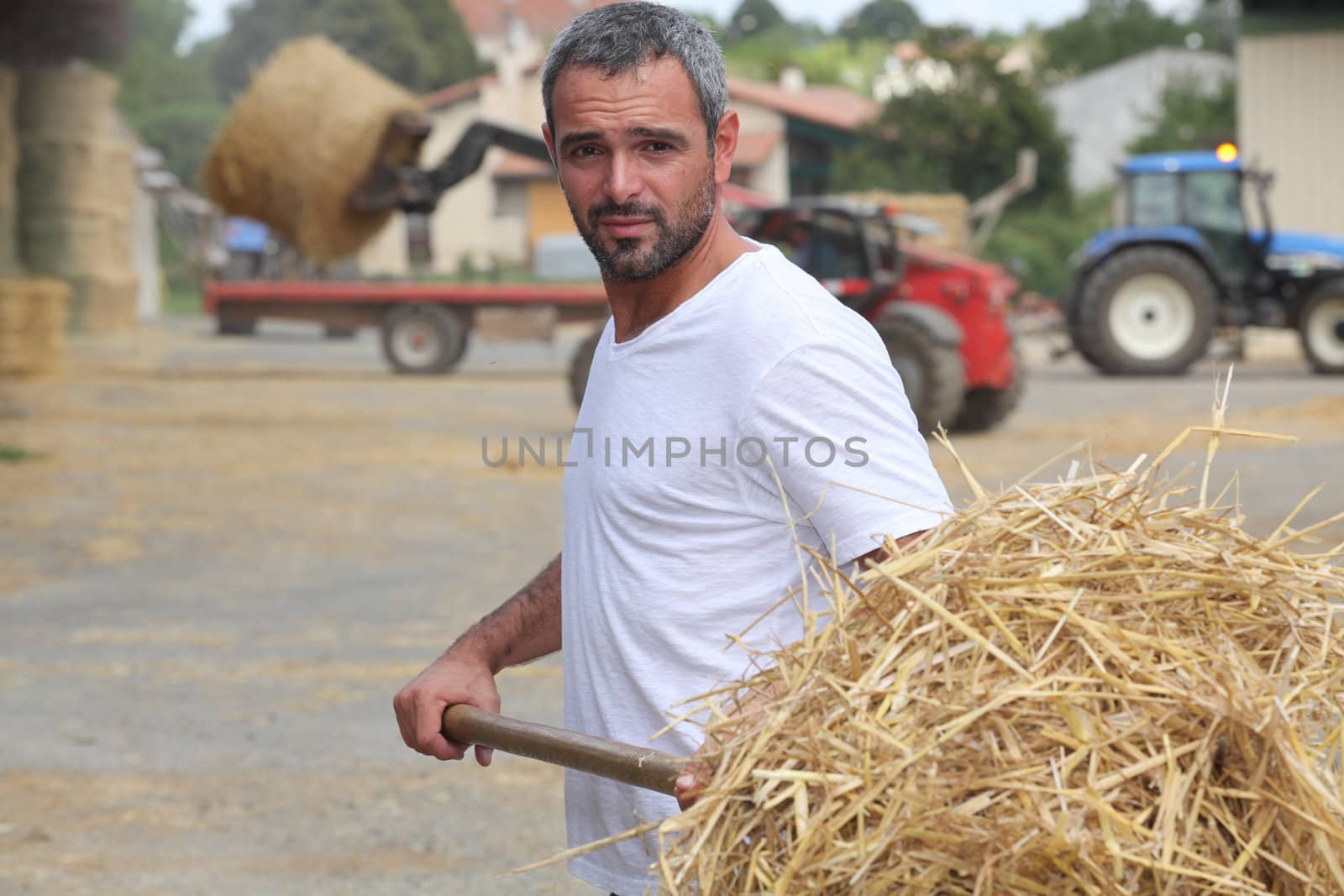 Farmer bailing hay by phovoir
