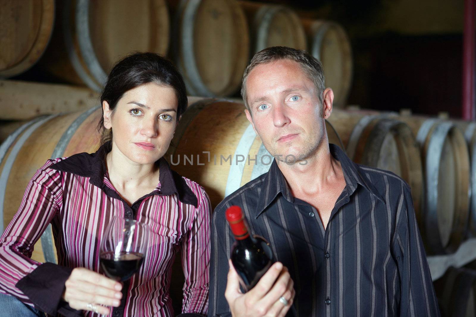 Man and woman with glass and bottle of wine