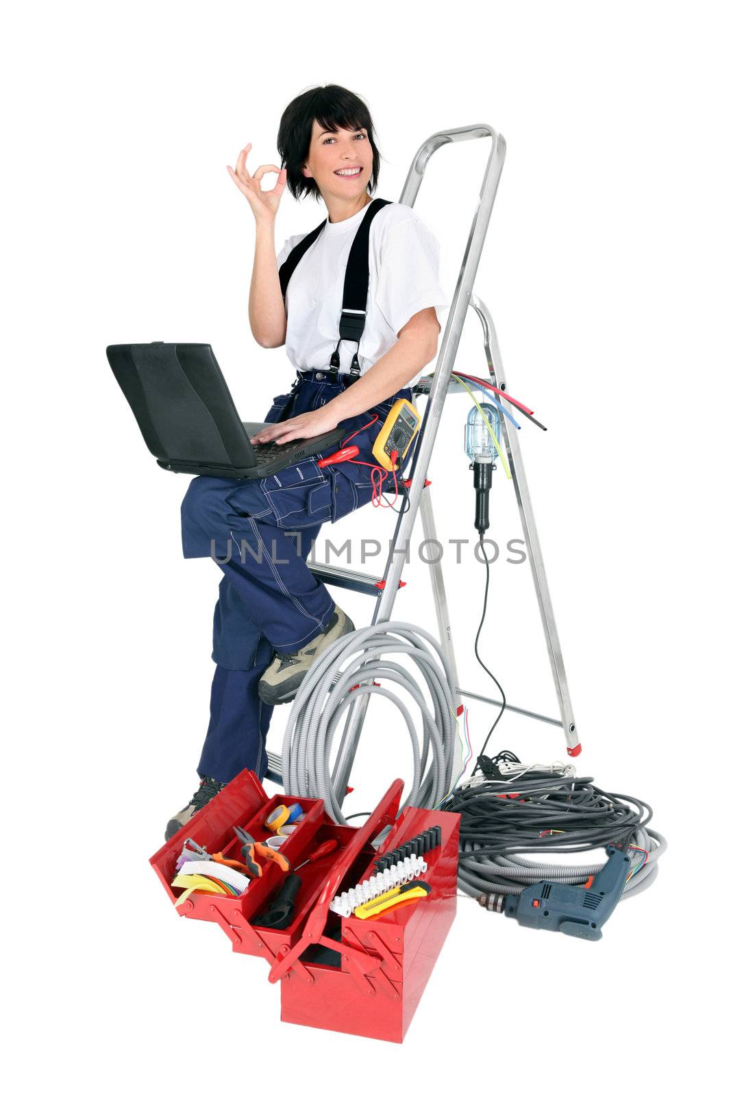 Female electrician with a laptop