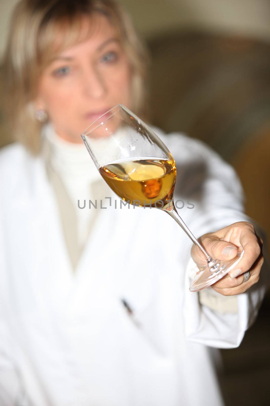 Woman examining a glass of wine