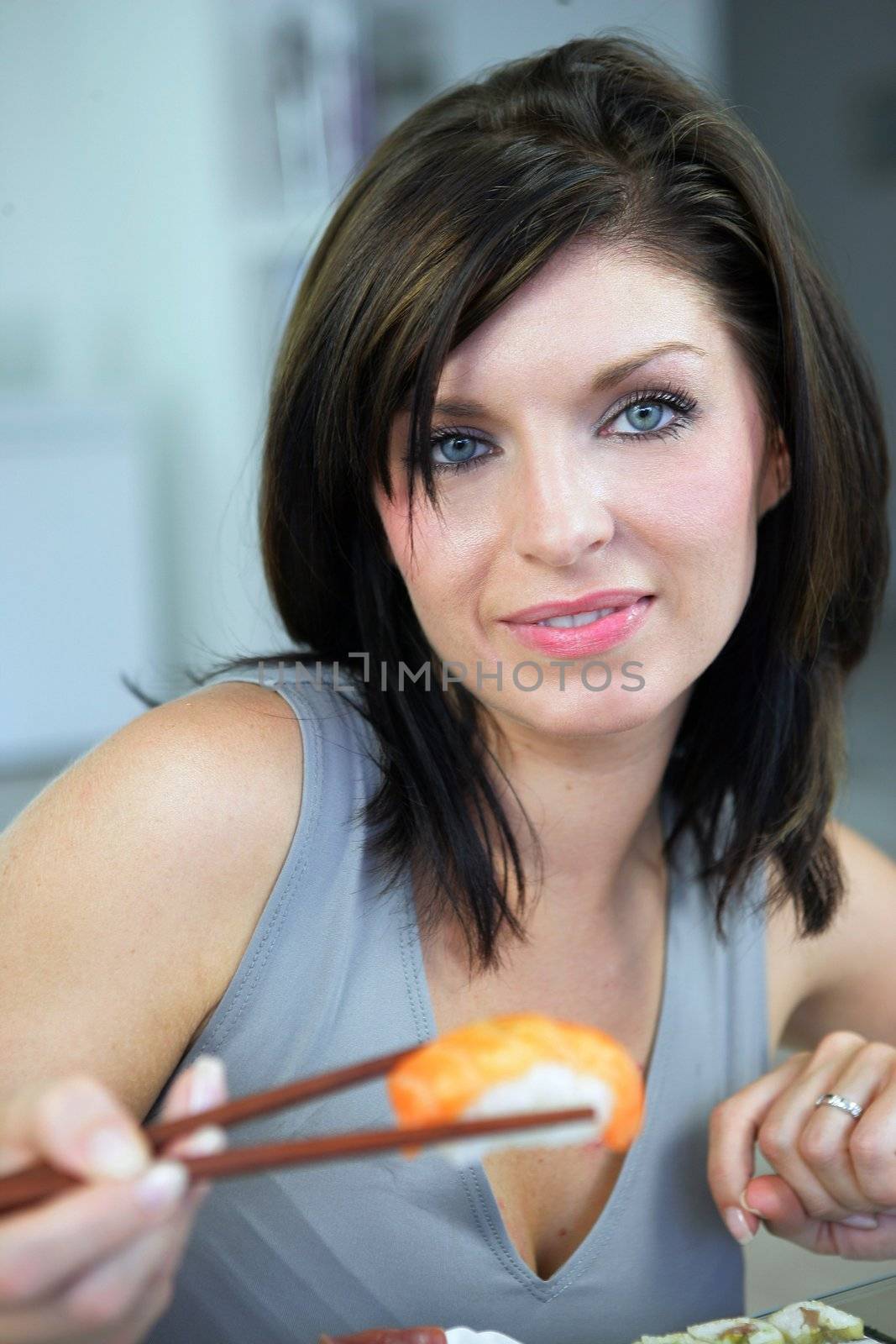 Woman eating sushi